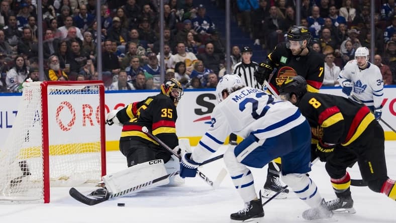 Jan 20, 2024; Vancouver, British Columbia, CAN; Toronto Maple Leafs defenseman Jake McCabe (22) scores on Vancouver Canucks goalie Thatcher Demko (35) in the second period at Rogers Arena. Mandatory Credit: Bob Frid-USA TODAY Sports