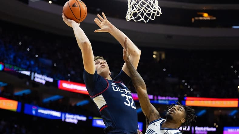 Jan 20, 2024; Philadelphia, Pennsylvania, USA; Connecticut Huskies center Donovan Clingan (32) drives for a shot against Villanova Wildcats forward Jordann Dumont (10) during the first half at Wells Fargo Center. Mandatory Credit: Bill Streicher-USA TODAY Sports