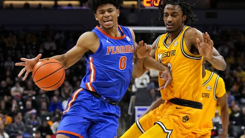 Jan 20, 2024; Columbia, Missouri, USA; Florida Gators guard Zyon Pullin (0) drives against Missouri Tigers forward Aidan Shaw (23) during the second half at Mizzou Arena. Mandatory Credit: Jay Biggerstaff-USA TODAY Sports
