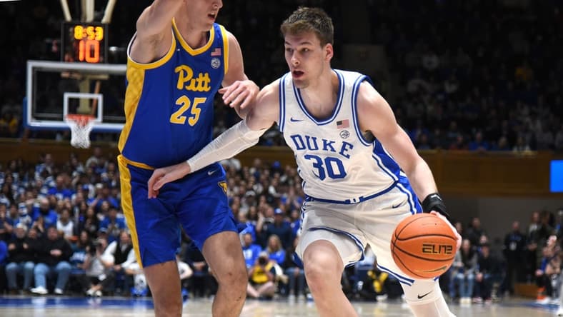 Jan 20, 2024; Durham, North Carolina, USA; Duke Blue Devils center Kyle Filipowski (30) drives to the basket as Pittsburgh Panthers forward Guillermo Diaz Graham (25) defends during the second half at Cameron Indoor Stadium. The Panthers won 80-76. Mandatory Credit: Rob Kinnan-USA TODAY Sports