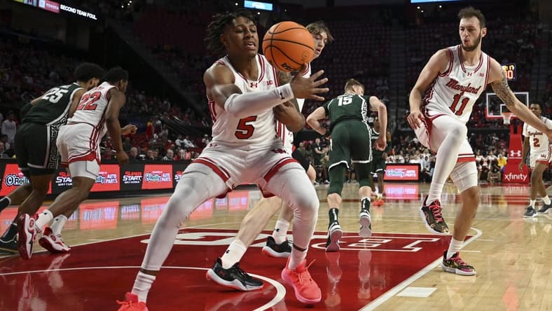 Jan 21, 2024; College Park, Maryland, USA;  Maryland Terrapins guard DeShawn Harris-Smith (5) reaches for a loose ball during the first half against the Michigan State Spartans at Xfinity Center. Mandatory Credit: Tommy Gilligan-USA TODAY Sports