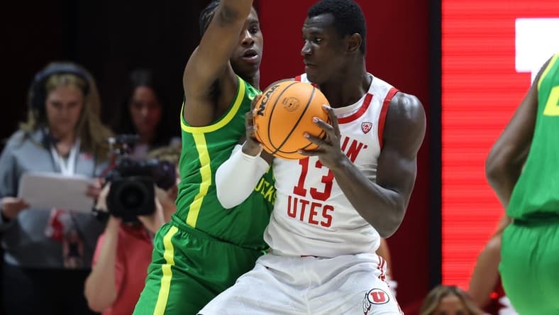 Jan 21, 2024; Salt Lake City, Utah, USA; Utah Utes center Keba Keita (13) posts up against Oregon Ducks forward Mookie Cook (11) during the first half at Jon M. Huntsman Center. Mandatory Credit: Rob Gray-USA TODAY Sports