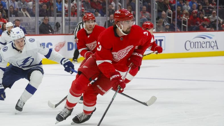 Jan 21, 2024; Detroit, Michigan, USA; Detroit Red Wings defenseman Justin Holl (3) handles the puck during the first period at Little Caesars Arena. Mandatory Credit: Brian Bradshaw Sevald-USA TODAY Sports