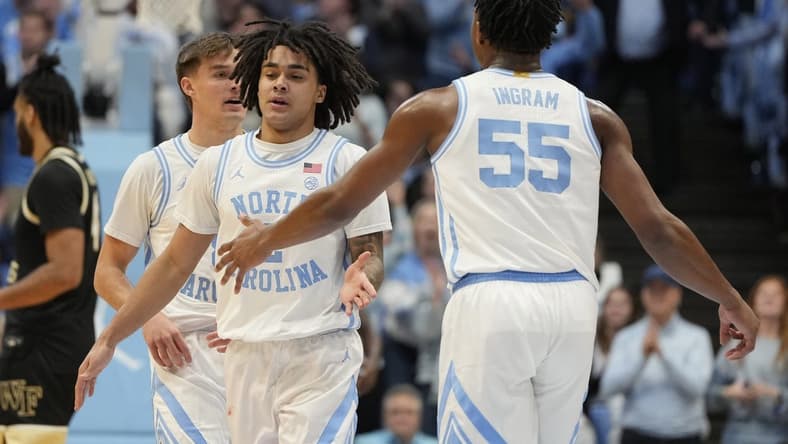 Jan 22, 2024; Chapel Hill, North Carolina, USA;  North Carolina Tar Heels guard Elliot Cadeau (2) with forward Harrison Ingram (55) in the first half at Dean E. Smith Center. Mandatory Credit: Bob Donnan-USA TODAY Sports