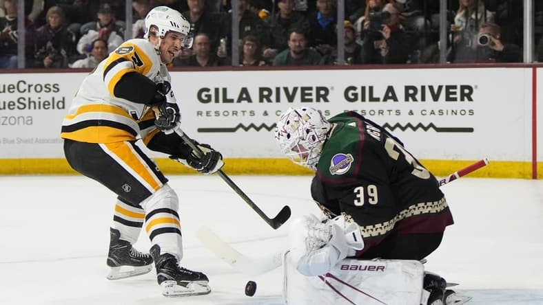 Jan 22, 2024; Tempe, Arizona, USA; Arizona Coyotes goaltender Connor Ingram (39) makes the save on Pittsburgh Penguins center Sidney Crosby (87) in the first period at Mullett Arena. Mandatory Credit: Rick Scuteri-USA TODAY Sports