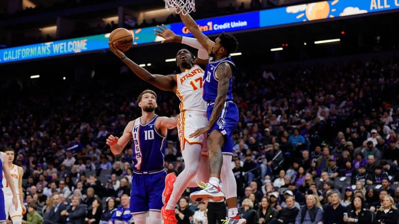 Jan 22, 2024; Sacramento, California, USA; Atlanta Hawks forward Onyeka Okongwu (17) drives to the basket against Sacramento Kings guard Malik Monk (0) during the second quarter at Golden 1 Center. Mandatory Credit: Sergio Estrada-USA TODAY Sports