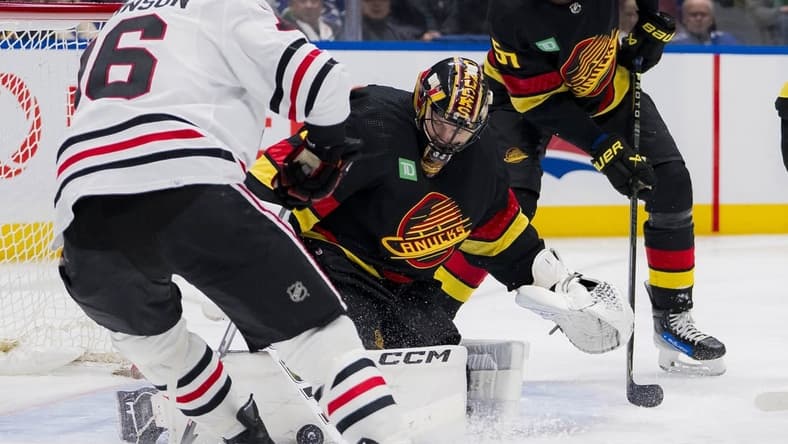 Jan 22, 2024; Vancouver, British Columbia, CAN; Vancouver Canucks goalie Thatcher Demko (35) makes a save on Chicago Blackhawks forward Jason Dickinson (16) in the second period at Rogers Arena. Mandatory Credit: Bob Frid-USA TODAY Sports