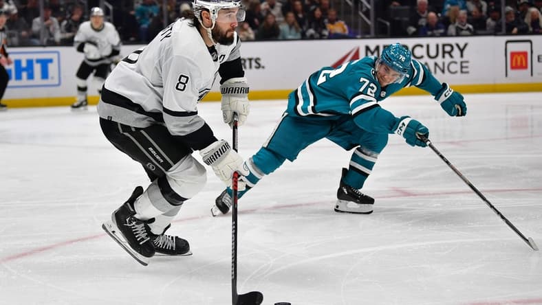 Jan 22, 2024; Los Angeles, California, USA; Los Angeles Kings defenseman Drew Doughty (8) moves the puck against San Jose Sharks left wing William Eklund (72) during the third period at Crypto.com Arena. Mandatory Credit: Gary A. Vasquez-USA TODAY Sports