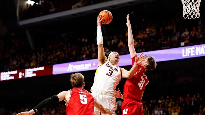 Jan 23, 2024; Minneapolis, Minnesota, USA; Minnesota Golden Gophers forward Dawson Garcia (3) shoots as Wisconsin Badgers forward Nolan Winter (31) defends during the first half at Williams Arena. Mandatory Credit: Matt Krohn-USA TODAY Sports