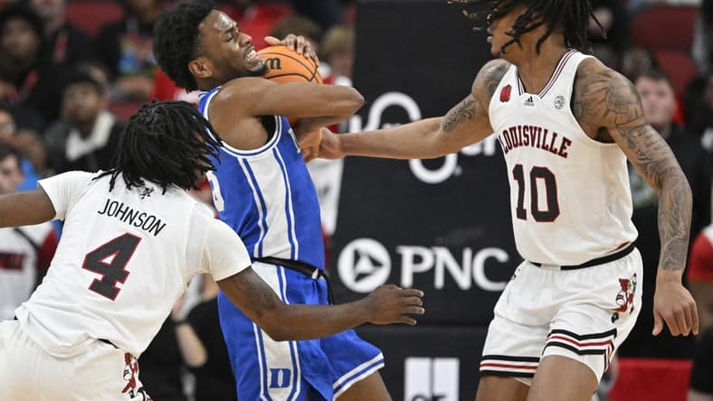 Jan 23, 2024; Louisville, Kentucky, USA;  Duke Blue Devils guard Jeremy Roach (3) battles Louisville Cardinals forward Kaleb Glenn (10) and guard Ty-Laur Johnson (4) during the first half at KFC Yum! Center. Mandatory Credit: Jamie Rhodes-USA TODAY Sports