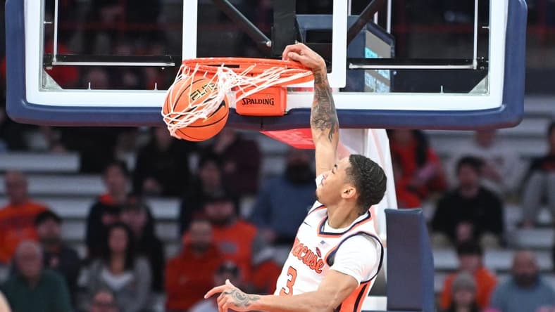 Jan 23, 2024; Syracuse, New York, USA; Syracuse Orange forward Benny Williams (13) dunks the ball against the Florida State Seminoles in the first half at the JMA Wireless Dome. Mandatory Credit: Mark Konezny-USA TODAY Sports