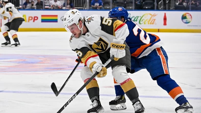 Jan 23, 2024; Elmont, New York, USA; New York Islanders defenseman Sebastian Aho (25) chases Vegas Golden Knights right wing Sheldon Rempal (56) during the first period at UBS Arena. Mandatory Credit: Dennis Schneidler-USA TODAY Sports