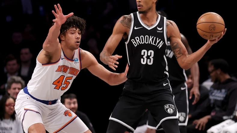 Jan 23, 2024; Brooklyn, New York, USA; Brooklyn Nets center Nic Claxton (33) looks to pass the ball against New York Knicks center Jericho Sims (45) during the first quarter at Barclays Center. Mandatory Credit: Brad Penner-USA TODAY Sports