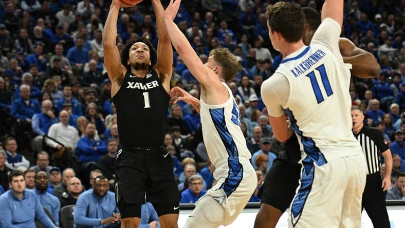 Jan 23, 2024; Omaha, Nebraska, USA;  Xavier Musketeers guard Desmond Claude (1) scores over Creighton Bluejays guard Baylor Scheierman (55) in the first half at CHI Health Center Omaha. Mandatory Credit: Steven Branscombe-USA TODAY Sports