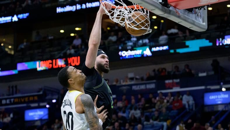Jan 23, 2024; New Orleans, Louisiana, USA; New Orleans Pelicans forward Larry Nance Jr. (22) dunks against Utah Jazz forward John Collins (20) during the first half at Smoothie King Center. Mandatory Credit: Matthew Hinton-USA TODAY Sports