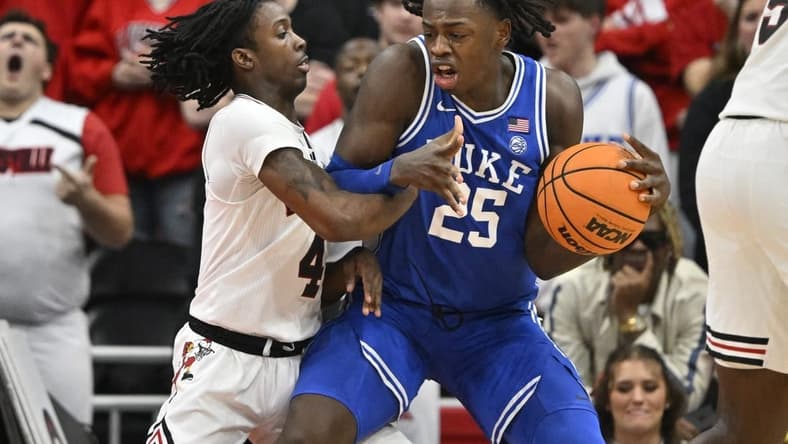 Jan 23, 2024; Louisville, Kentucky, USA; Duke Blue Devils forward Mark Mitchell (25) posts up against Louisville Cardinals guard Ty-Laur Johnson (4) during the second half at KFC Yum! Center. Duke defeated Louisville 83-69. Mandatory Credit: Jamie Rhodes-USA TODAY Sports