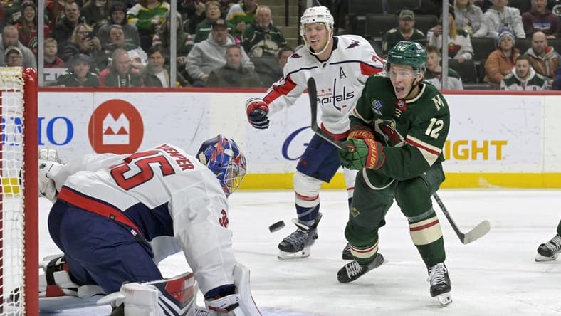 Jan 23, 2024; Saint Paul, Minnesota, USA; Minnesota Wild forward Matt Boldy (12) shoots the puck wide of the net of Washington Capitals goalie Darcy Kuemper (35) during the second period at Xcel Energy Center. Mandatory Credit: Nick Wosika-USA TODAY Sports