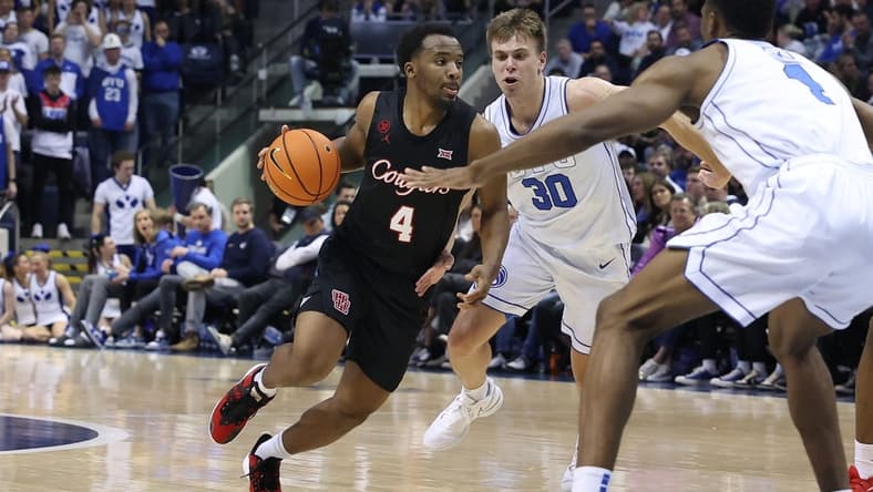 Jan 23, 2024; Provo, Utah, USA; Houston Cougars guard L.J. Cryer (4) dribbles past Brigham Young Cougars guard Dallin Hall (30) during the first half at Marriott Center. Mandatory Credit: Rob Gray-USA TODAY Sports
