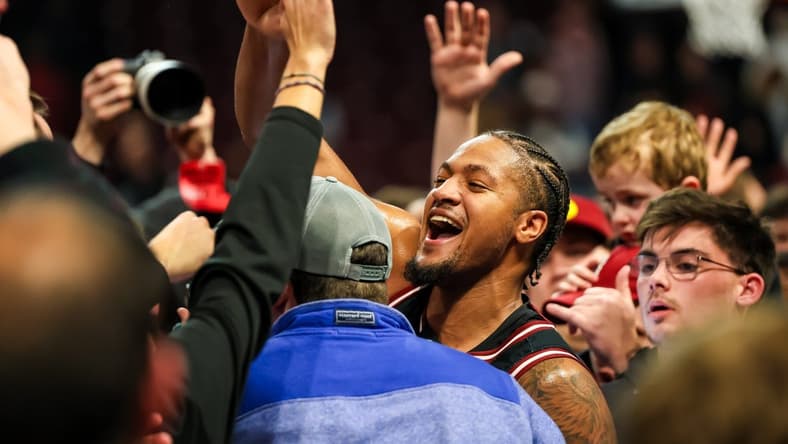 Jan 23, 2024; Columbia, South Carolina, USA; South Carolina Gamecocks guard Ta'Lon Cooper (55) celebrates with students after beating the Kentucky Wildcats at Colonial Life Arena. Mandatory Credit: Jeff Blake-USA TODAY Sports