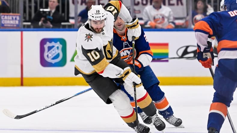 Jan 23, 2024; Elmont, New York, USA; Vegas Golden Knights center Nicolas Roy (10) skates with the puck defended by New York Islanders defenseman Noah Dobson (8) during the third period at UBS Arena. Mandatory Credit: Dennis Schneidler-USA TODAY Sports