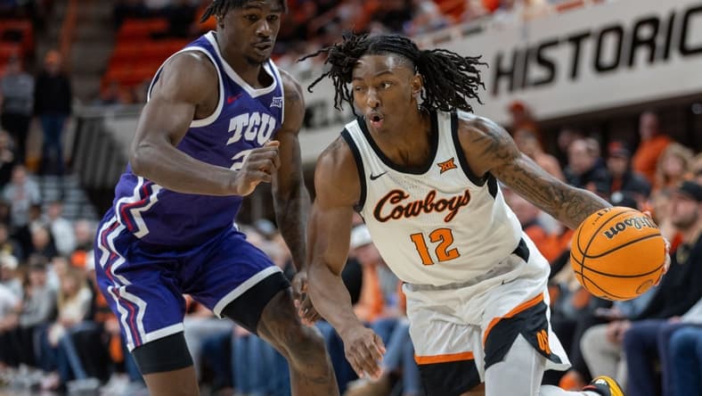 Jan 23, 2024; Stillwater, Oklahoma, USA; Oklahoma State Cowboys guard Javon Small (12) drives around TCU Horned Frogs forward Emanuel Miller (2) during the first half at Gallagher-Iba Arena. Mandatory Credit: William Purnell-USA TODAY Sports