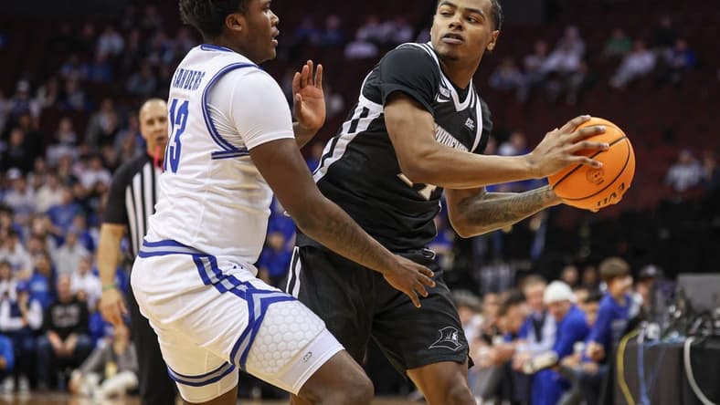 Jan 24, 2024; Newark, New Jersey, USA;  Providence Friars guard Luke Fonts (24) looks to pass as Seton Hall Pirates guard Jaquan Sanders (13) defends during the first half at Prudential Center. Mandatory Credit: Vincent Carchietta-USA TODAY Sports