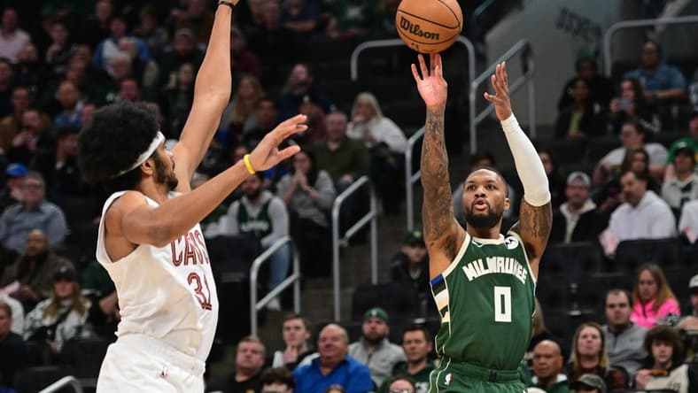 Jan 24, 2024; Milwaukee, Wisconsin, USA; Milwaukee Bucks guard Damian Lillard (0) takes a shot against Cleveland Cavaliers center Jarrett Allen (31) in the first quarter at Fiserv Forum. Mandatory Credit: Benny Sieu-USA TODAY Sports
