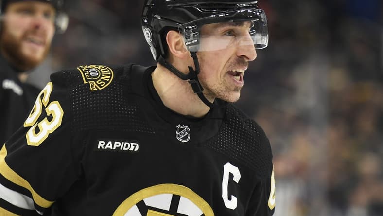 Jan 24, 2024; Boston, Massachusetts, USA;  Boston Bruins left wing Brad Marchand (63) has words for the refereee after being called for a penalty during the first period against the Carolina Hurricanes at TD Garden. Mandatory Credit: Bob DeChiara-USA TODAY Sports