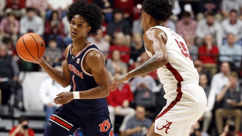 Jan 24, 2024; Tuscaloosa, Alabama, USA; Auburn Tigers guard Aden Holloway (1) dribbles around Alabama Crimson Tide guard Aaron Estrada (55) during the first half at Coleman Coliseum. Mandatory Credit: Butch Dill-USA TODAY Sports