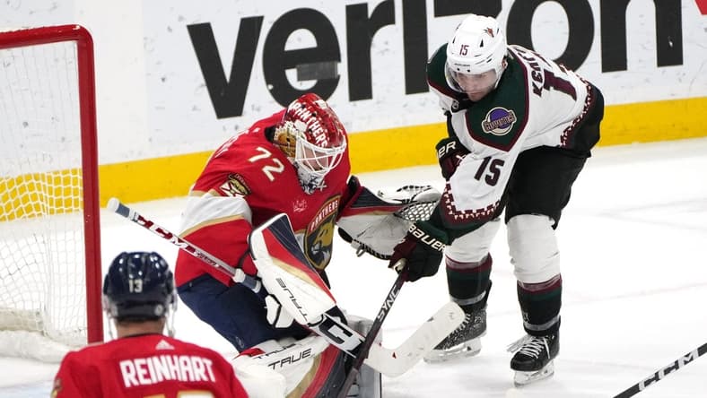 Jan 24, 2024; Sunrise, Florida, USA; Florida Panthers goaltender Sergei Bobrovsky (72) makes a save as Arizona Coyotes center Alexander Kerfoot (15) closes in during the second period at Amerant Bank Arena. Mandatory Credit: Jim Rassol-USA TODAY Sports