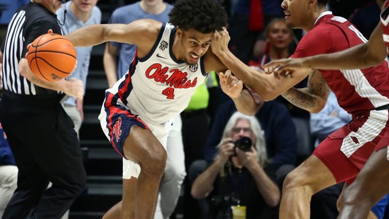 Jan 24, 2024; Oxford, Mississippi, USA; Mississippi Rebels forward Jaemyn Brakefield (4) drives to the basket as Arkansas Razorbacks forward Jalen Graham (11) defends during the first half at The Sandy and John Black Pavilion at Ole Miss. Mandatory Credit: Petre Thomas-USA TODAY Sports