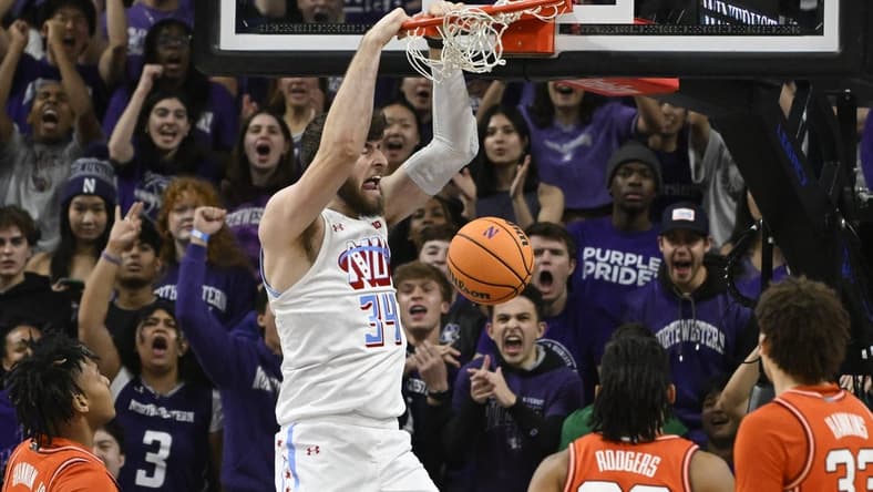 Jan 24, 2024; Evanston, Illinois, USA;  Northwestern Wildcats center Matthew Nicholson (34) dunks the ball against the Illinois Fighting Illini during the first half at Welsh-Ryan Arena. Mandatory Credit: Matt Marton-USA TODAY Sports