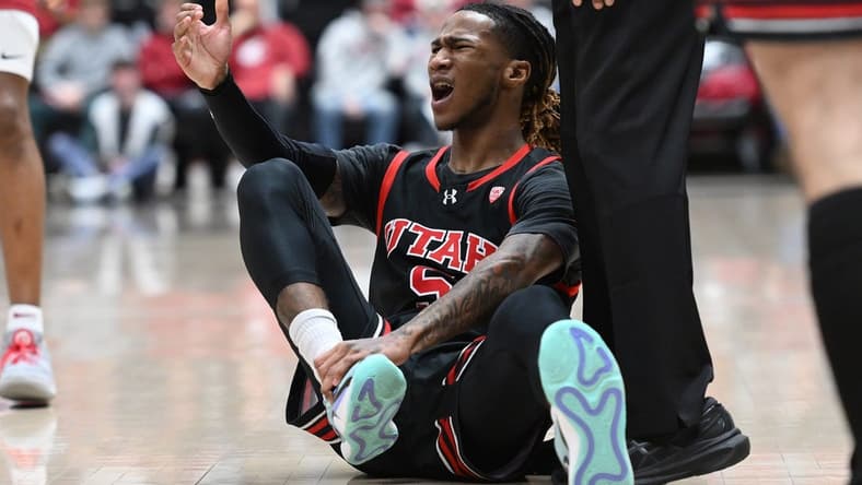 Jan 24, 2024; Pullman, Washington, USA; Utah Utes guard Deivon Smith (5) grab his ankle during a game against the Washington State Cougars in the first half at Friel Court at Beasley Coliseum. Mandatory Credit: James Snook-USA TODAY Sports
