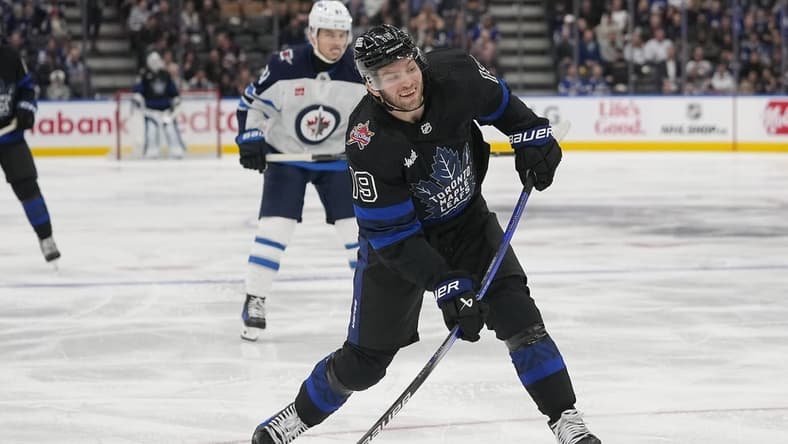 Jan 24, 2024; Toronto, Ontario, CAN; Toronto Maple Leafs forward Calle Jarnkrok (19) goes to shoot the puck against the Winnipeg Jets during the third period at Scotiabank Arena. Mandatory Credit: John E. Sokolowski-USA TODAY Sports