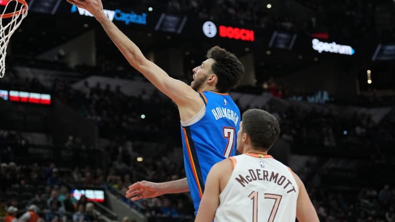 Jan 24, 2024; San Antonio, Texas, USA;  Oklahoma City Thunder forward Chet Holmgren (7) shoots in front of San Antonio Spurs forward Doug McDermott (17) in the second half at Frost Bank Center. Mandatory Credit: Daniel Dunn-USA TODAY Sports