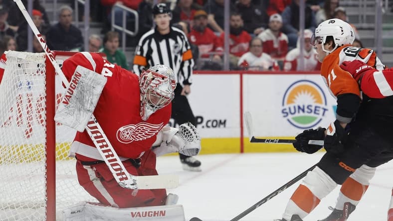 Jan 25, 2024; Detroit, Michigan, USA; Detroit Red Wings goaltender Alex Lyon (34) makes a save on Philadelphia Flyers right wing Tyson Foerster (71) in the first period at Little Caesars Arena. Mandatory Credit: Rick Osentoski-USA TODAY Sports