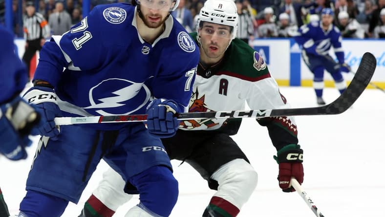 Jan 25, 2024; Tampa, Florida, USA; Tampa Bay Lightning center Anthony Cirelli (71) and Arizona Coyotes center Nick Schmaltz (8) look after the puck during the first period at Amalie Arena. Mandatory Credit: Kim Klement Neitzel-USA TODAY Sports