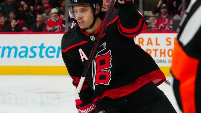 Jan 25, 2024; Raleigh, North Carolina, USA;  Carolina Hurricanes center Sebastian Aho (20) scores a goal against the New Jersey Devils during the first period at PNC Arena. Mandatory Credit: James Guillory-USA TODAY Sports