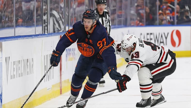Jan 25, 2024; Edmonton, Alberta, CAN; Edmonton Oilers forward Connor McDavid (97) carries the puck around Chicago Blackhawks forward Colin Blackwell (43) during the first period at Rogers Place. Mandatory Credit: Perry Nelson-USA TODAY Sports