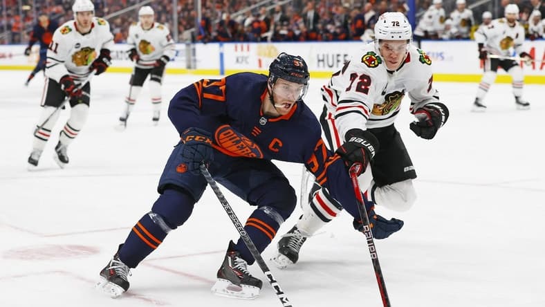 Jan 25, 2024; Edmonton, Alberta, CAN; Edmonton Oilers forward Connor McDavid (97) carries the puck around Chicago Blackhawks defensemen Alex Vlasic (72) during the third period at Rogers Place. Mandatory Credit: Perry Nelson-USA TODAY Sports