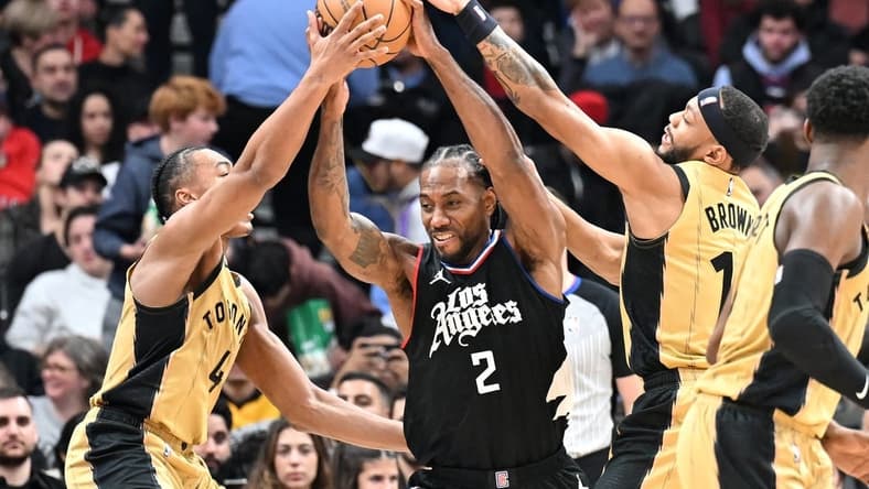 Jan 26, 2024; Toronto, Ontario, CAN; Los Angeles Clippers forward Kawhi Leonard (2) battles for the ball against Toronto Raptors forward Scottie Barnes (4) and guard Bruce Brown (11) in the first half at Scotiabank Arena. Mandatory Credit: Dan Hamilton-USA TODAY Sports