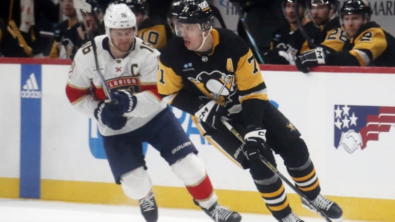 Jan 26, 2024; Pittsburgh, Pennsylvania, USA; Pittsburgh Penguins center Evgeni Malkin (71) moves the puck against Florida Panthers center Aleksander Barkov (16) during the second period at PPG Paints Arena. Mandatory Credit: Charles LeClaire-USA TODAY Sports