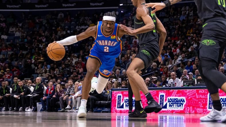 Jan 26, 2024; New Orleans, Louisiana, USA; Oklahoma City Thunder guard Shai Gilgeous-Alexander (2) dribbles against New Orleans Pelicans guard Trey Murphy III (25) during the first half at Smoothie King Center. Mandatory Credit: Stephen Lew-USA TODAY Sports