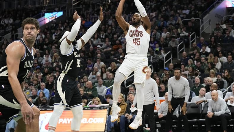 Jan 26, 2024; Milwaukee, Wisconsin, USA; Cleveland Cavaliers guard Donovan Mitchell (45) shoots against Milwaukee Bucks forward Jae Crowder (99) during the third quarter at Fiserv Forum. Mandatory Credit: Jeff Hanisch-USA TODAY Sports