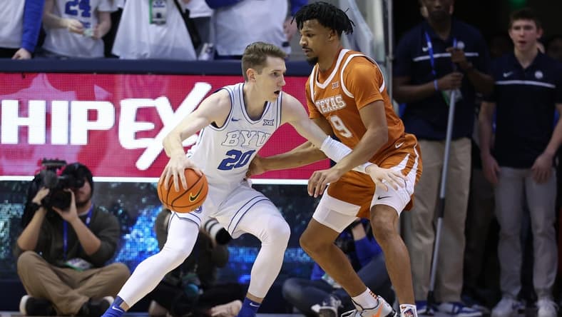 Jan 27, 2024; Provo, Utah, USA; Brigham Young Cougars guard Spencer Johnson (20) drives to the basket against Texas Longhorns guard Ithiel Horton (9) during the first half at Marriott Center. Mandatory Credit: Rob Gray-USA TODAY Sports
