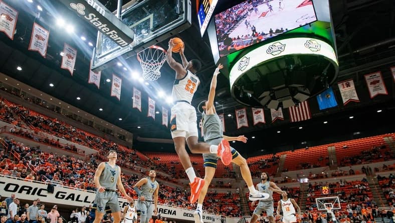 Jan 27, 2024; Stillwater, Oklahoma, USA; Oklahoma State Cowboys center Brandon Garrison (23) puts up a shot against the West Virginia Mountaineers during the first half at Gallagher-Iba Arena. Mandatory Credit: William Purnell-USA TODAY Sports