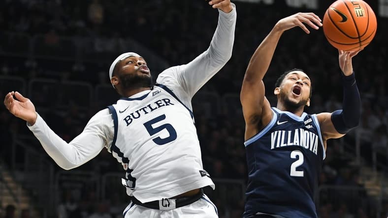 Jan 27, 2024; Indianapolis, Indiana, USA; Butler Bulldogs guard Posh Alexander (5) and Villanova Wildcats guard Mark Armstrong (2) battle for a rebound during the first half at Hinkle Fieldhouse. Mandatory Credit: Robert Goddin-USA TODAY Sports
