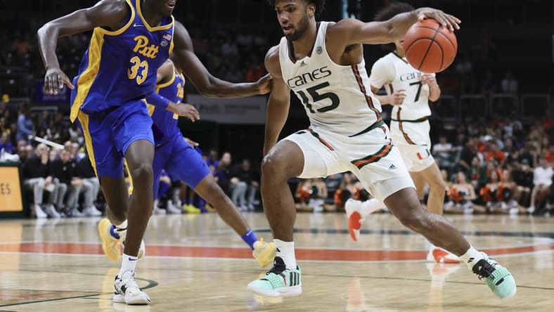 Jan 27, 2024; Coral Gables, Florida, USA; Miami Hurricanes forward Norchad Omier (15) drives to the basket against Pittsburgh Panthers center Federiko Federiko (33) during the second half at Watsco Center. Mandatory Credit: Sam Navarro-USA TODAY Sports