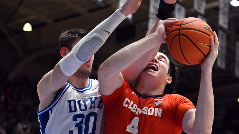 Jan 27, 2024; Durham, North Carolina, USA; Clemson Tigers forward Ian Schiefflelin (4) attempts to shot s Duke Blue Devils center Kyle Filipowski (30) defends during the first half at Cameron Indoor Stadium. Mandatory Credit: Rob Kinnan-USA TODAY Sports