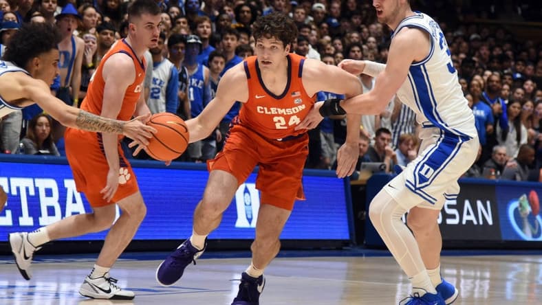 Jan 27, 2024; Durham, North Carolina, USA; Clemson Tigers center PJ Hall (24) drives to the basket as Duke Blue Devils center Kyle Filipowski (30) and guard Tyrese Proctor (5) defend during the first half at Cameron Indoor Stadium. Mandatory Credit: Rob Kinnan-USA TODAY Sports